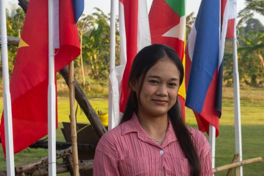 Fa in front of a range of flags on flagpoles