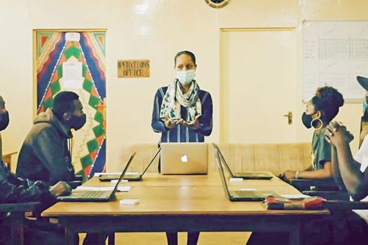 Ingabire teaching a group about computing