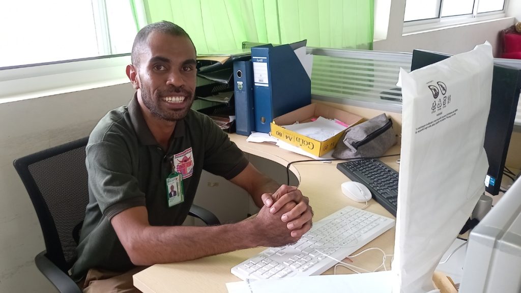 Agostinho sitting at his desk in his office