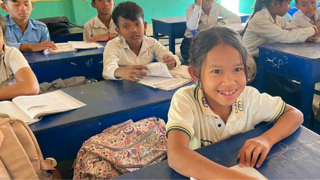 Kanika happily working in the classroom