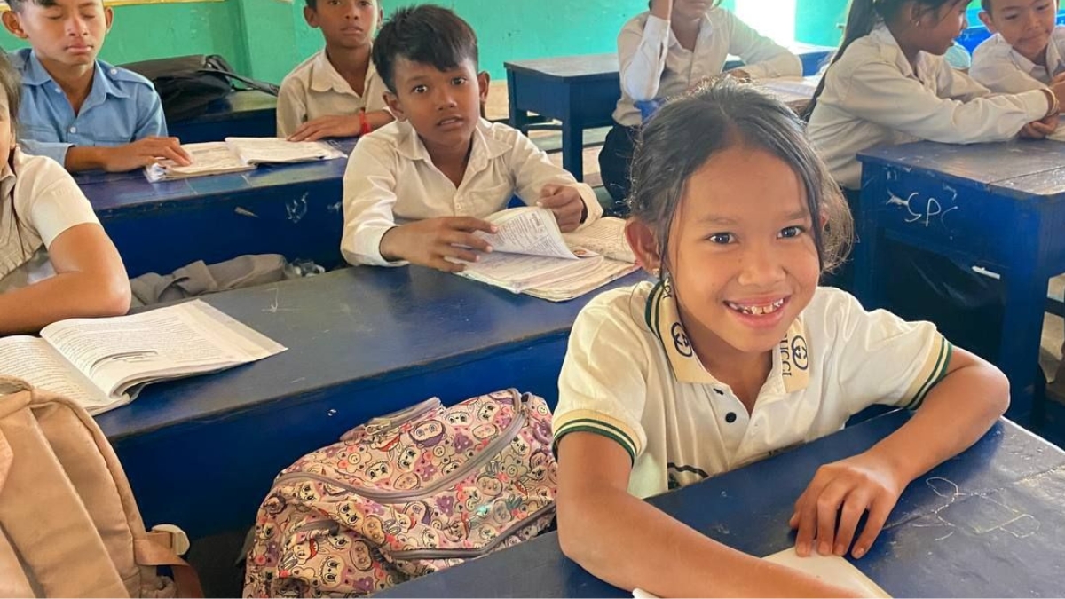 Kanika happily working in the classroom