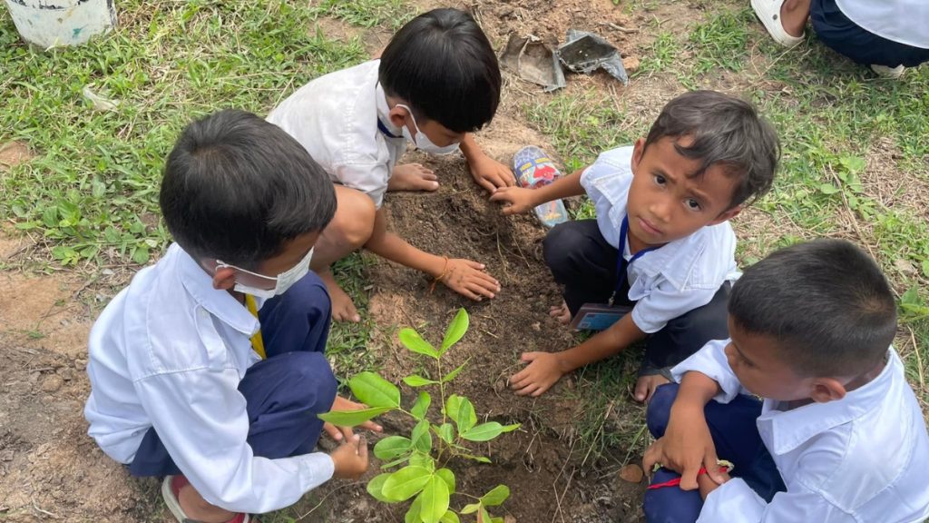 Young student planting a seedling