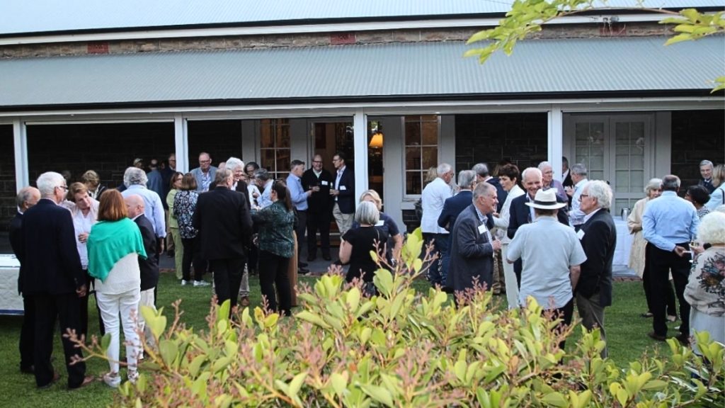 The crowd at Pilgrims project night 2024 gathered outside a beautiful colonial building in the early evening light