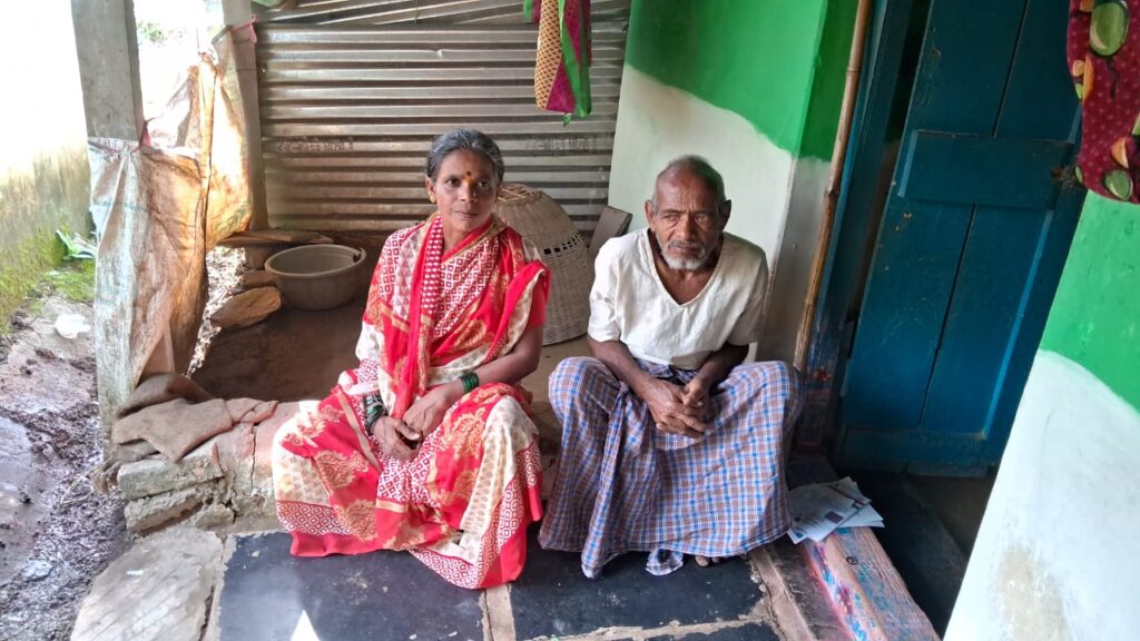 Nagavva sitting on the front porch with her husband Lakshman