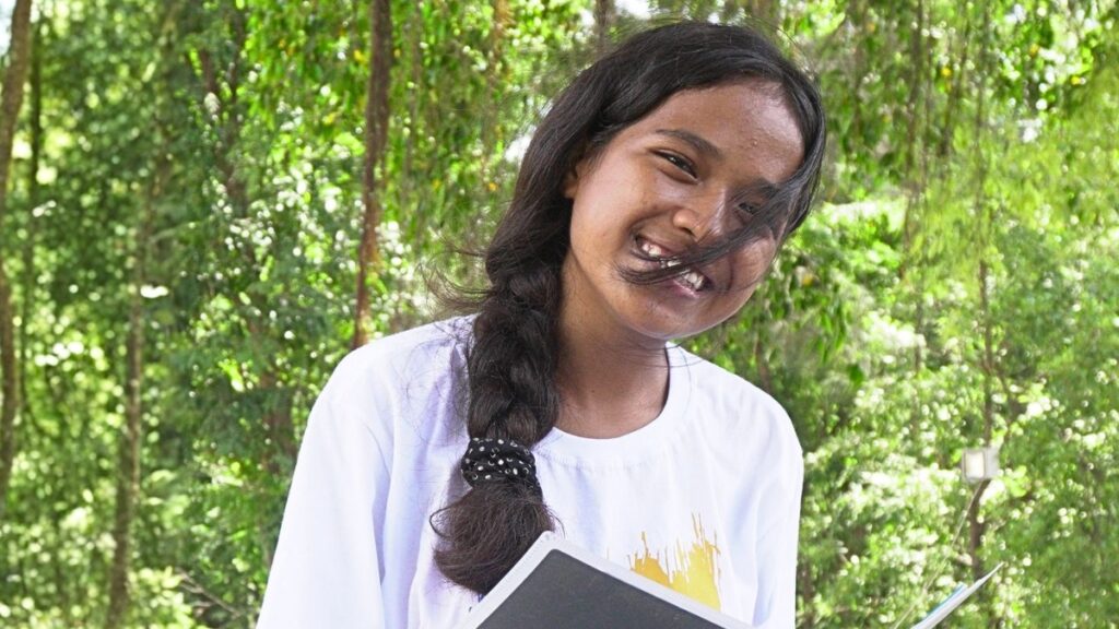 Pedrosa reading a book in the school garden
