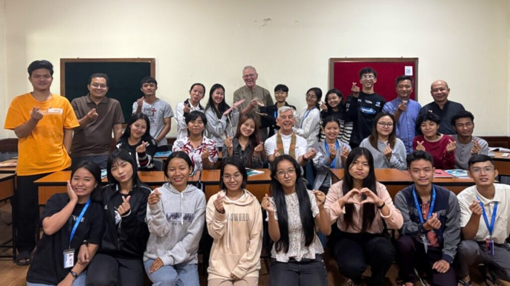 Students in the classroom waving to the camera
