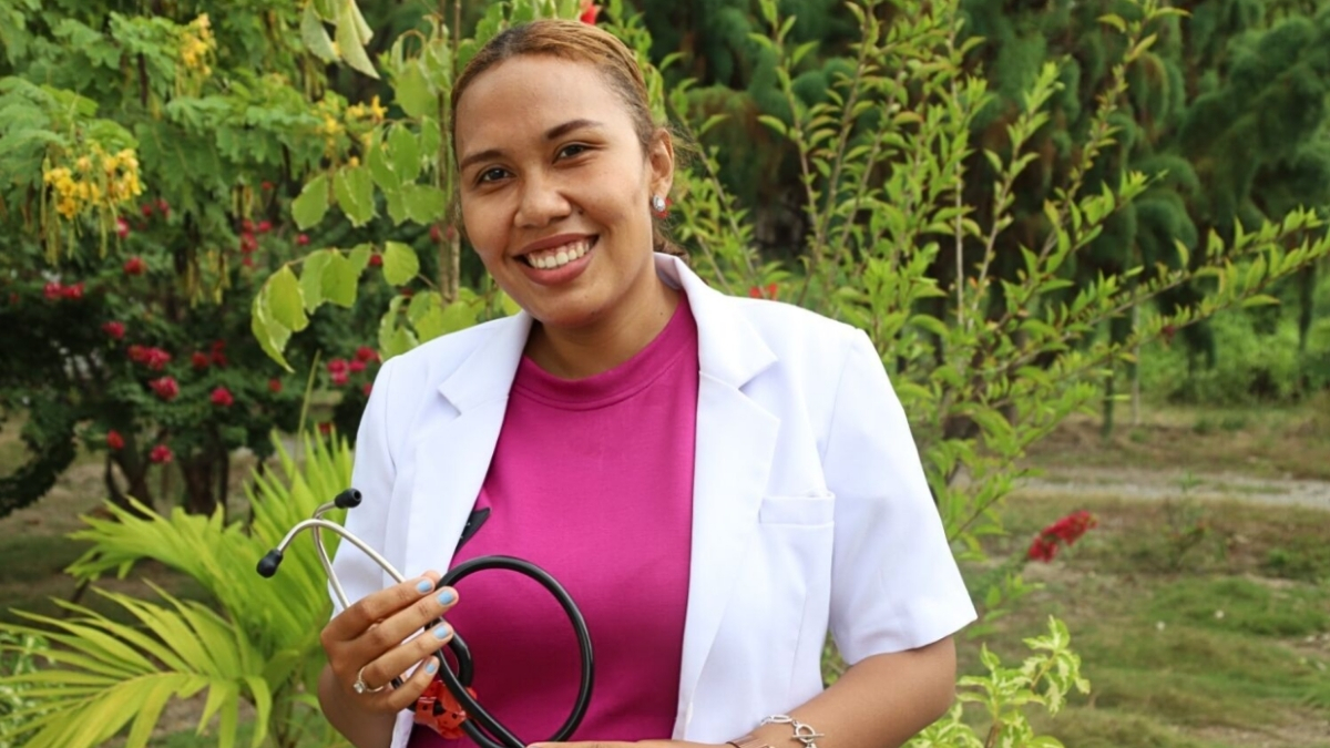 Dr Eva standing in the garden with her stethoscope in