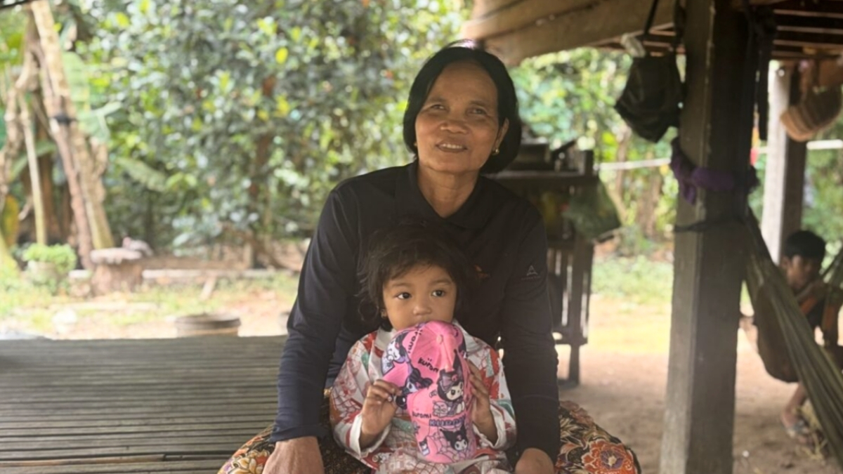 Hon Lei sitting on her front porch with her grand-daughter on her lap