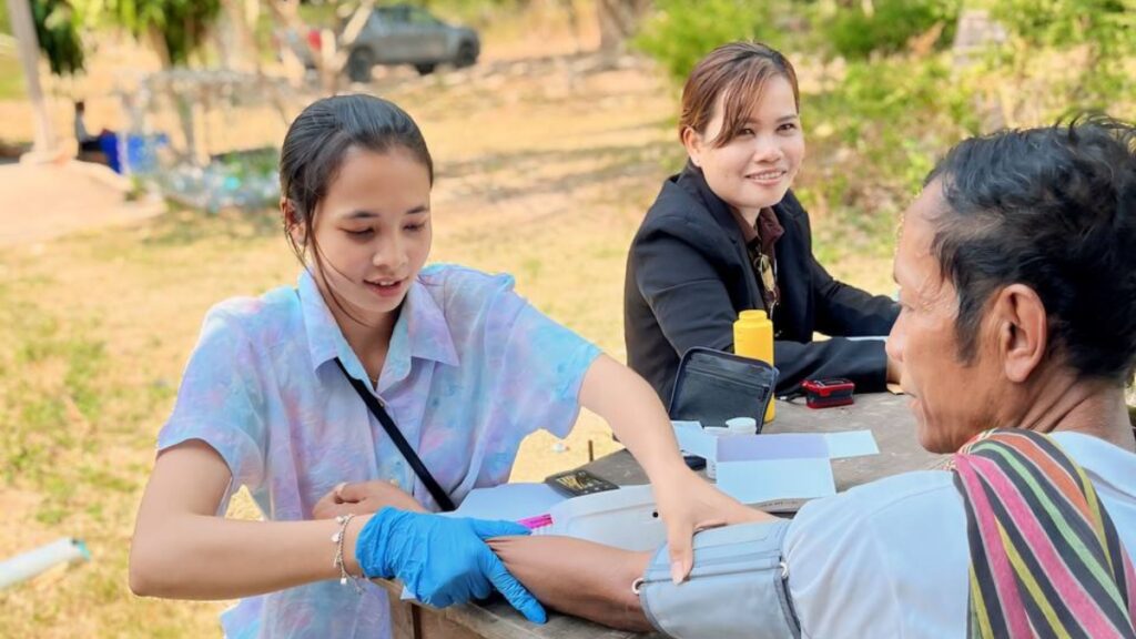 Jenny taking a villager's blood pressure