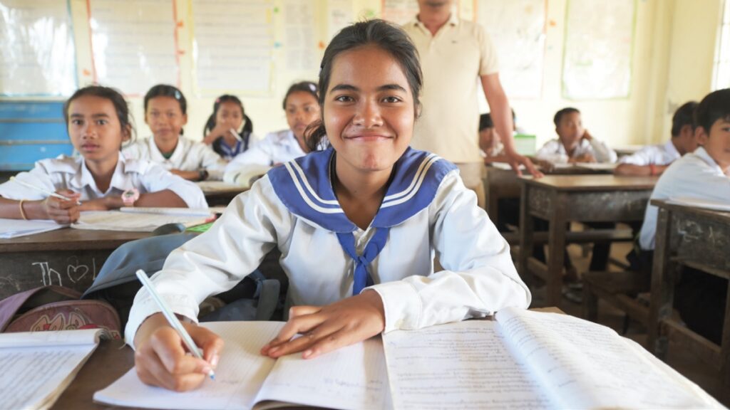 A girl filling out a questionnaire at her desk