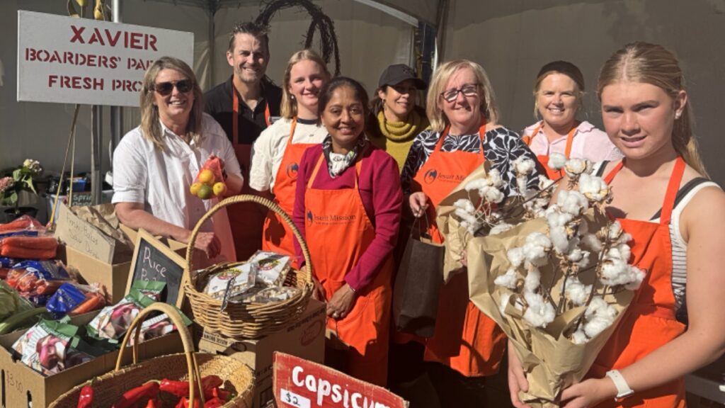 Volunteers at a fair stall selling fresh and sustainable produce