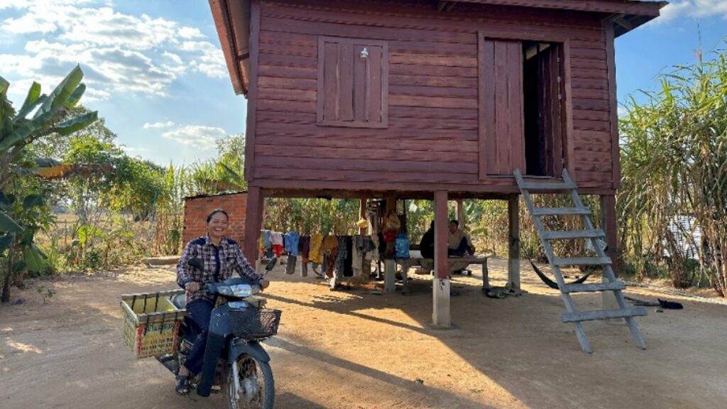 Tut Nga driving away from her home for another day selling fruit