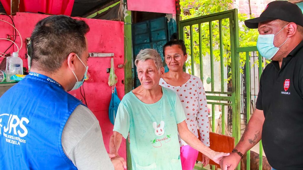 A Jesuit Relief Services team greeting a woman who has been displaced by the earthquake