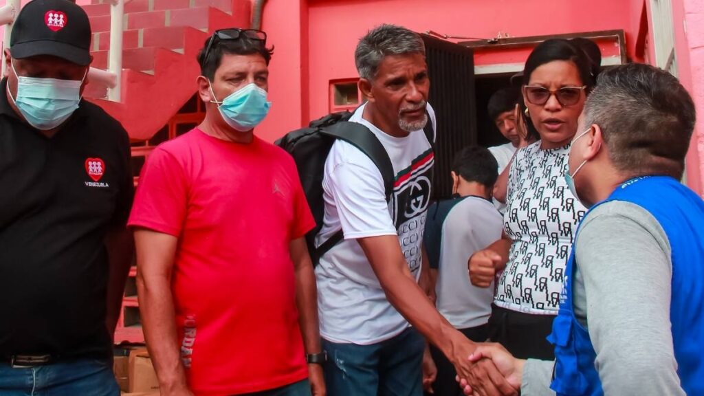 People who have been displaced by the earthquake meeting support workers