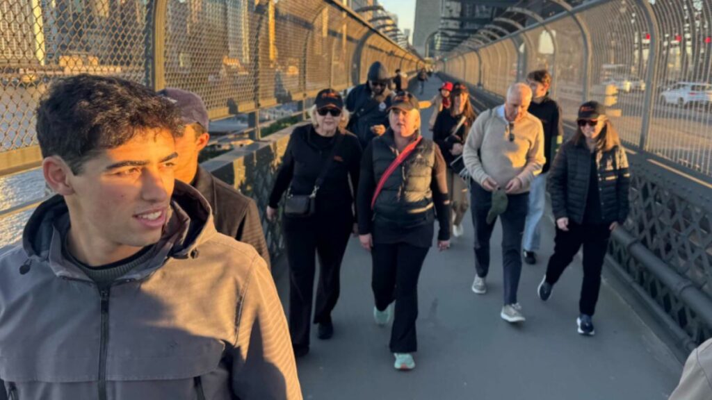 The Jesuit Mission and Cardoner teams walking across the Sydney harbour bridge