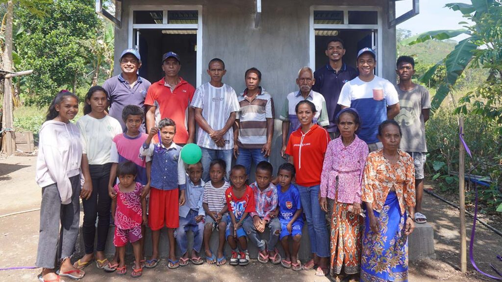 Community members gather outside one of the new toilet blocks made possible by the program