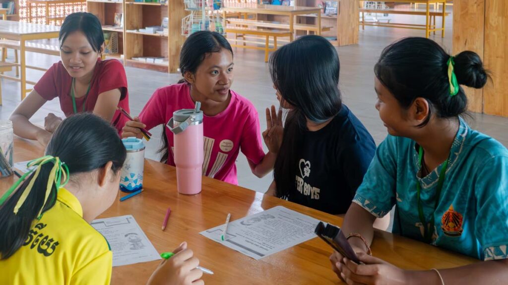 Chivita working with her classmates in the school library